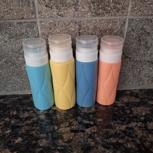 Set of Four Travel Bottles in Assorted Colors LIKE NEW